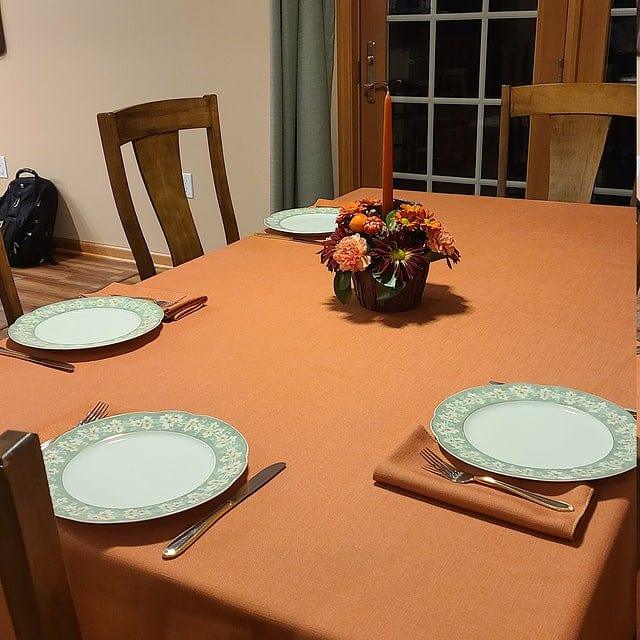 Fine dinner linens with matching napkins at a home style table with place settings