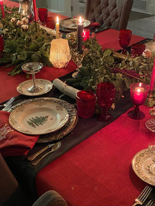 Elegant cotton linens on an exquisite holiday table with napkins and Christmas plates