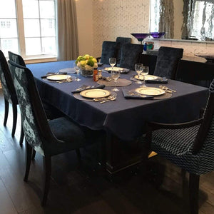 Cobalt Blue table linens in an upscale home with a flowered centerpiece by a window