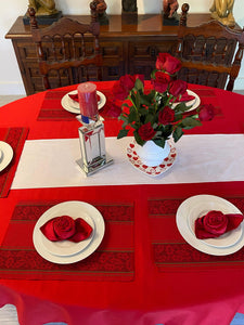 Romantic oval tablecloth setting, red linen tablecloth and napkins folded into roses