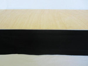 Poly Stage skirt with a flat wrap in black on a wooden stage