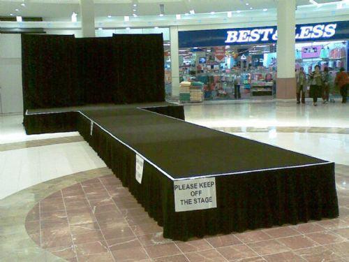 Black Polyester Stage skirt on an empty stage in a shopping mall