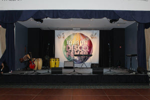 Blue Stage skirt on a performance stage during a disco music concert with banner and instruments
