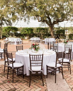 Outdoor wedding reception with white table linens