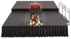 Stage skirt in black on a graduation ceremony stage with podium and flowers in front