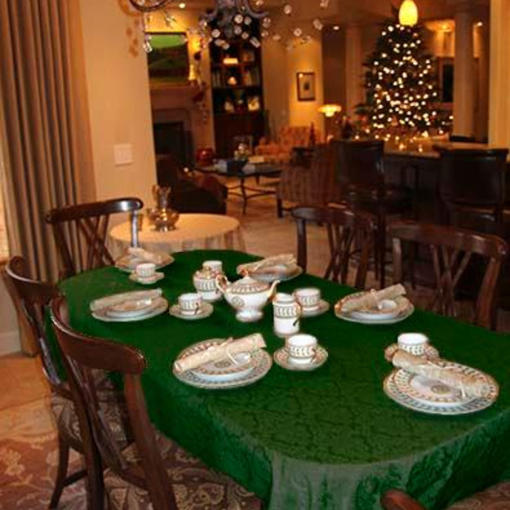 Hunter green Christmas tablecloth and dinner napkins on the table during the holidays.