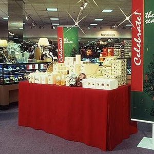  Fitted red tablecloth with merchandise on the table at a retail establishment 