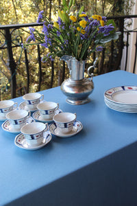 an elegant blue tablecloth on a rectangular tea serving table set up outdoors