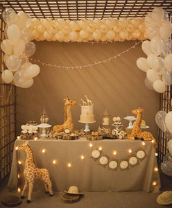 Faux Burlap tablecloth on a small table at a baby's first birthday party with cake and giraffe toys