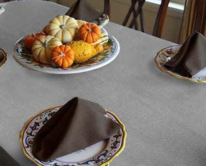 Silver Havana linen on a family table with green folded napkins and small pumpkins for Thanksgiving
