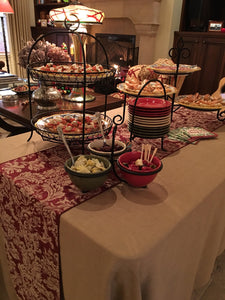 Formal Linens on a rectangular appetizer station table with food, plates, and table runner
