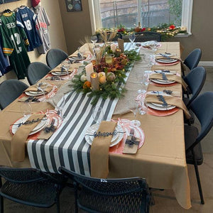 Natural tablecloth in a family Thanksgiving dinner setting with matching napkins and table runner