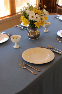 Fine linens on a rectangular table in a home easter daytime setting