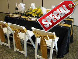 a black table cloth with gold runner and sashes on white chairs