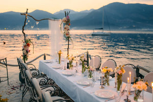 White table linens at a lavish destination wedding reception by the sea