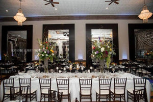 White Fine table linens on a large table in an elegant wedding reception