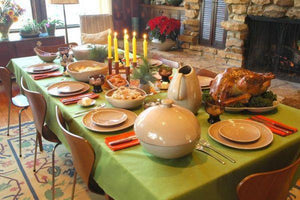 Holiday Linens on a Thanksgiving day dinner celebration with a turkey and other food.