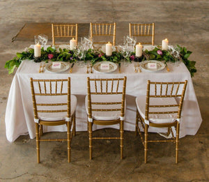 Poly Value Tablecloth on a rectangular wedding table with Plates and candles