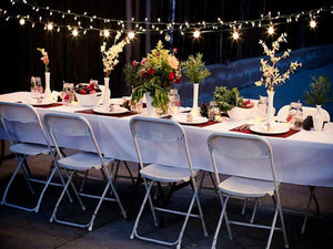 Elegant white linens on an outdoor dinner setting