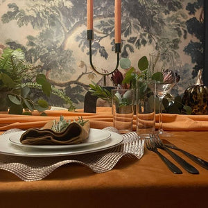 Fine Velvet tablecloth with a runner, candles, placemats, and plates