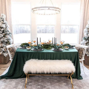 Hunter Green linens on a rectangular table during an elegant Christmas dinner by a window
