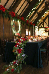 Velvet Tablecloth on a long table during a barn style wedding reception with candles