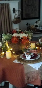 Round family table with Panama fine linen and table runner with candles and celebratory decor