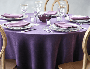 Our cobalt colored Panama dinner linen on a round dining table with place settings