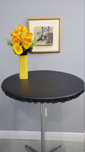 round vinyl tablecloth with a yellow vase and beautiful yellow flowers