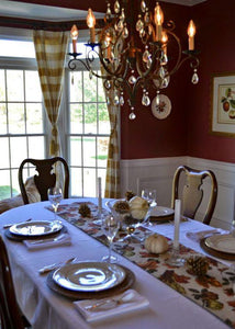 White Spun poly linens on a Thanksgiving decorated table with a printed runner and decorations
