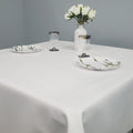White flannel backed vinyl tablecloth with white roses and plates