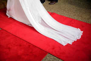Red Velvet Aisle Runner, shown with wedding dress tail on it